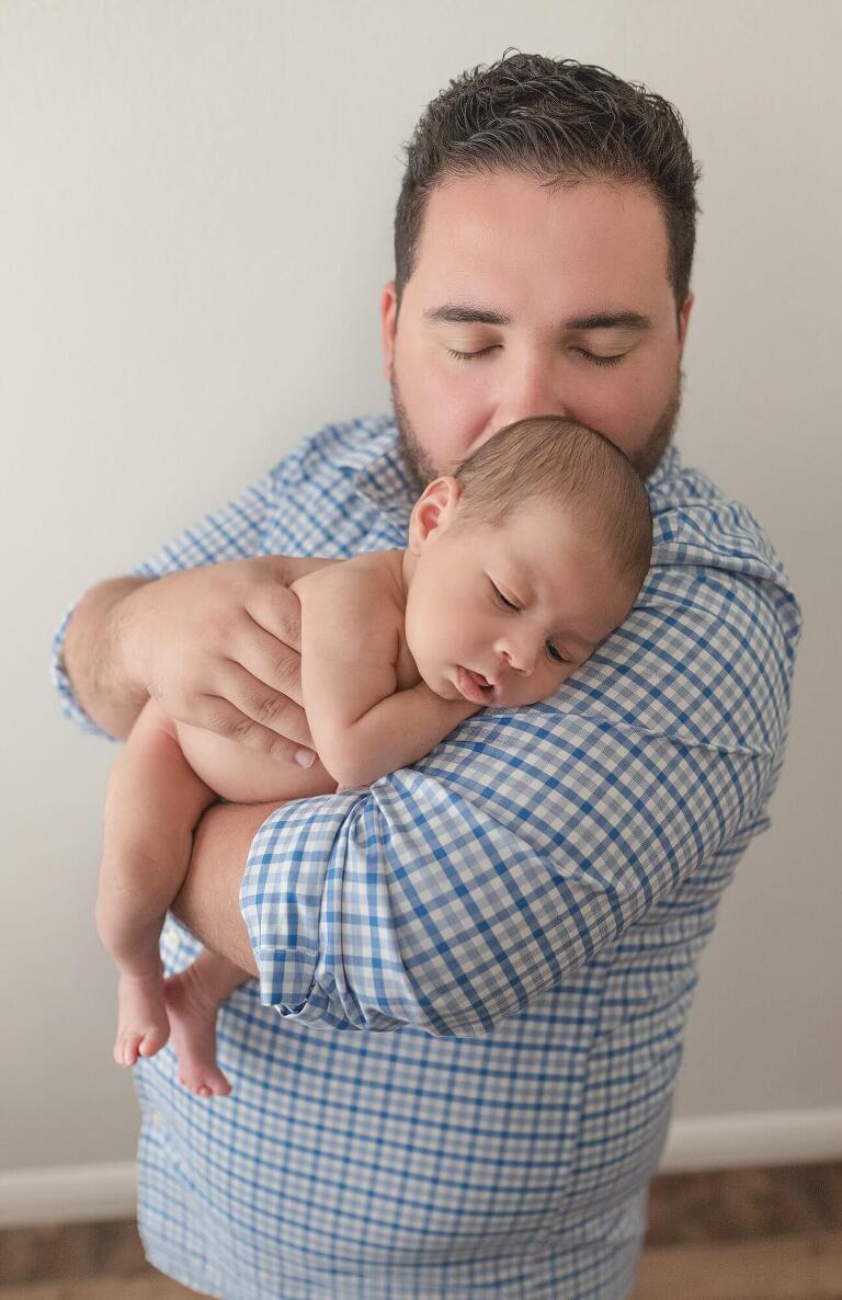 father holding newborn baby boy