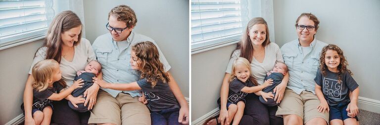 family with new baby sitting together on floor