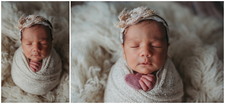 newborn girl holding tiny felt heart